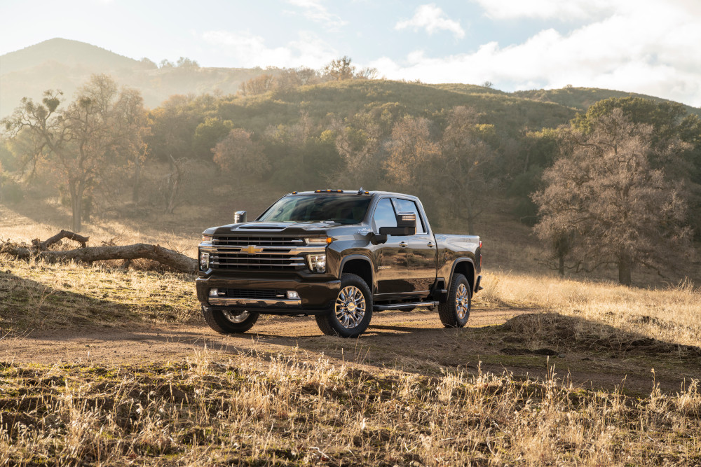 Black Chevrolet Silverado 2500 work truck in a field