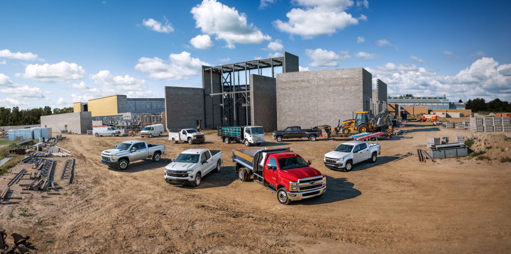 Chevrolet work trucks on a build site