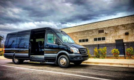 LA West Luxury Coach with sliding side door open, showcasing easy access and passenger capacity.