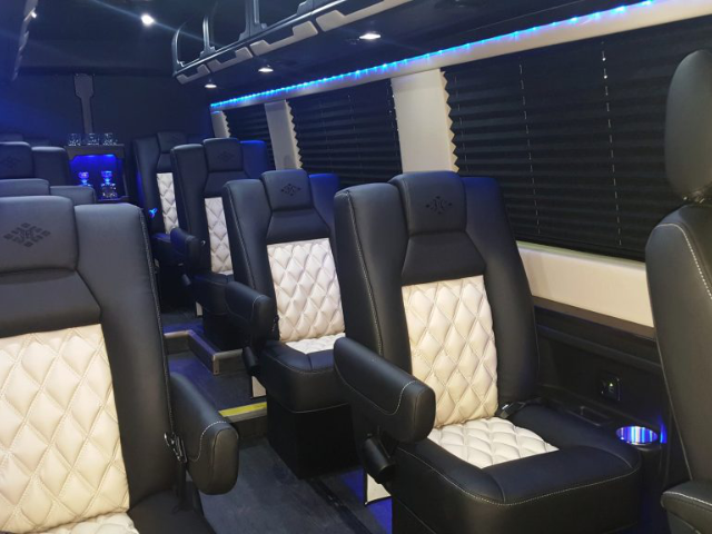 Luxury interior of an LA West Luxury Coach with comfortable, high-back quilted seats, perfect for executive or VIP transport.