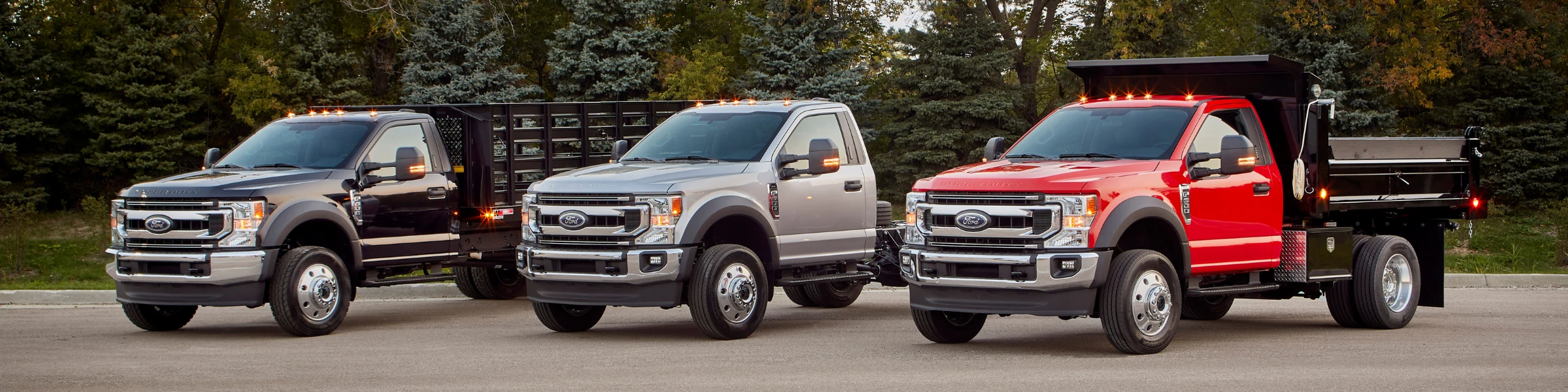 A wide shot of new upfitted Ford trucks and vans, ready for business, at Long-Lewis Ford of The Shoals.