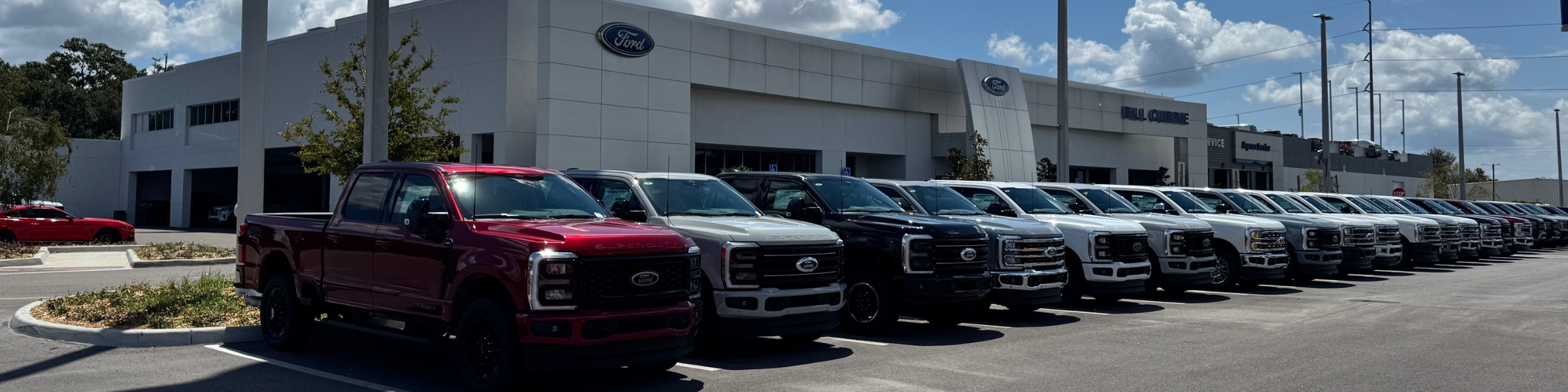 A lineup of Ford commercial pickups for sale at Bill Currie Ford in Tampa, FL.